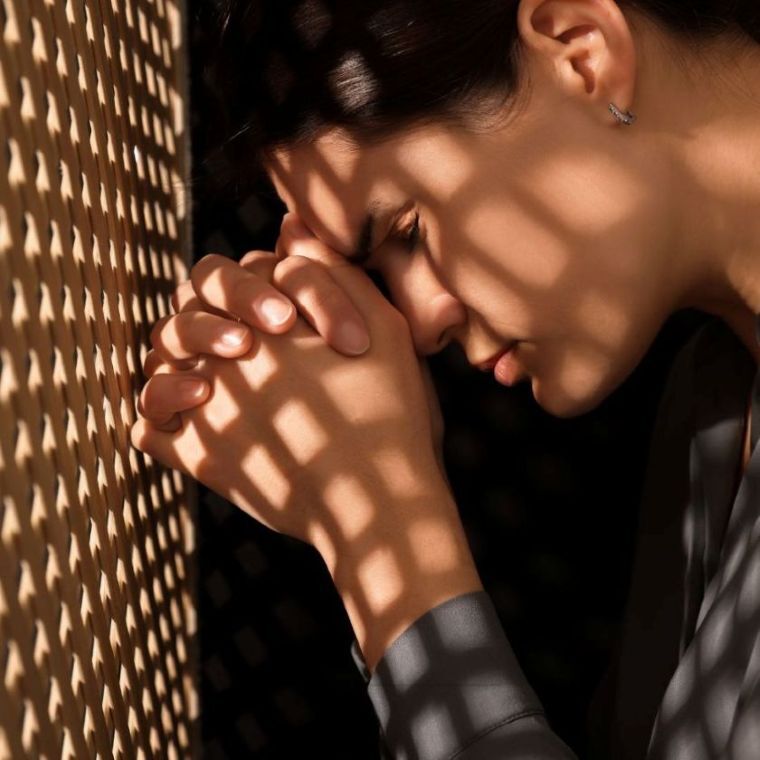 Repentant Woman during Confession near Wooden Partition in Booth 760 x 760